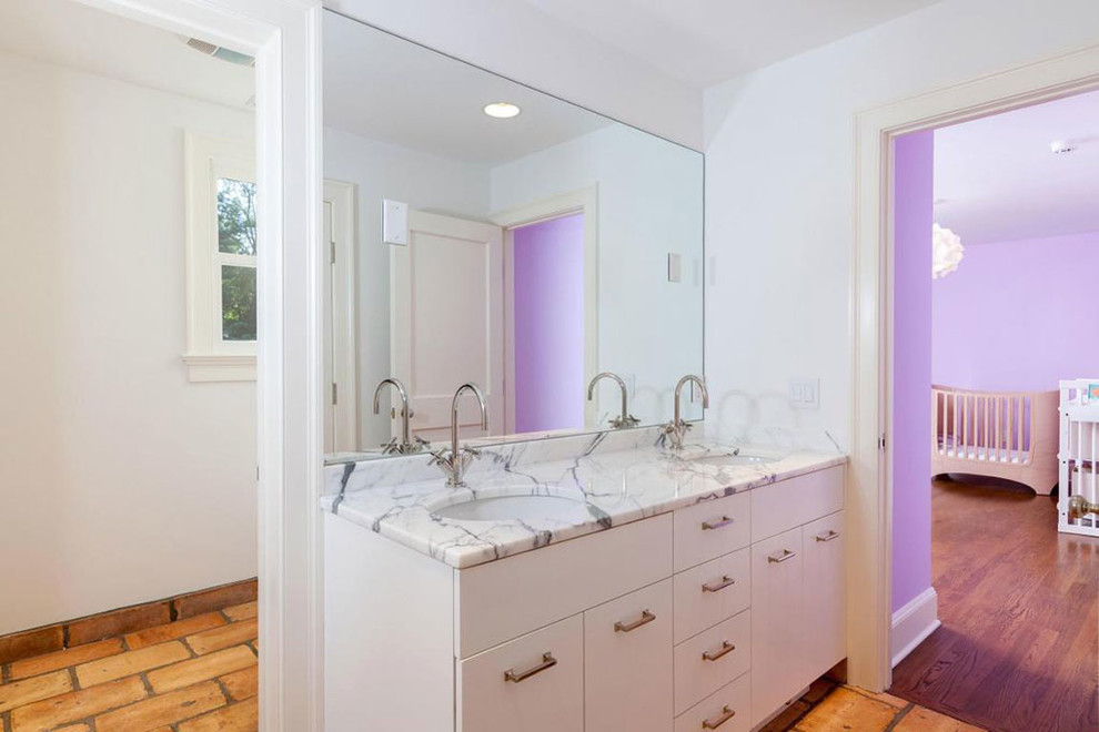 Bathroom - mid-sized transitional kids' brick floor and brown floor bathroom idea with flat-panel cabinets, white cabinets, white walls, an undermount sink and marble countertops