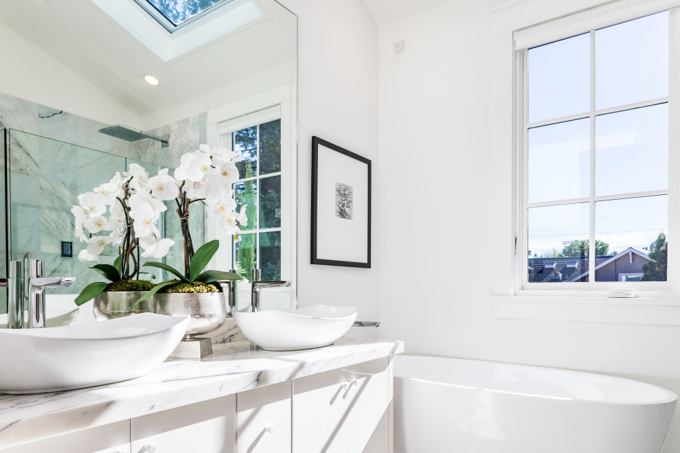 Design ideas for a large contemporary master bathroom in San Francisco with flat-panel cabinets, white cabinets, a freestanding tub, a curbless shower, a wall-mount toilet, blue tile, marble, white walls, marble floors, an integrated sink, marble benchtops, white floor, a hinged shower door and yellow benchtops.