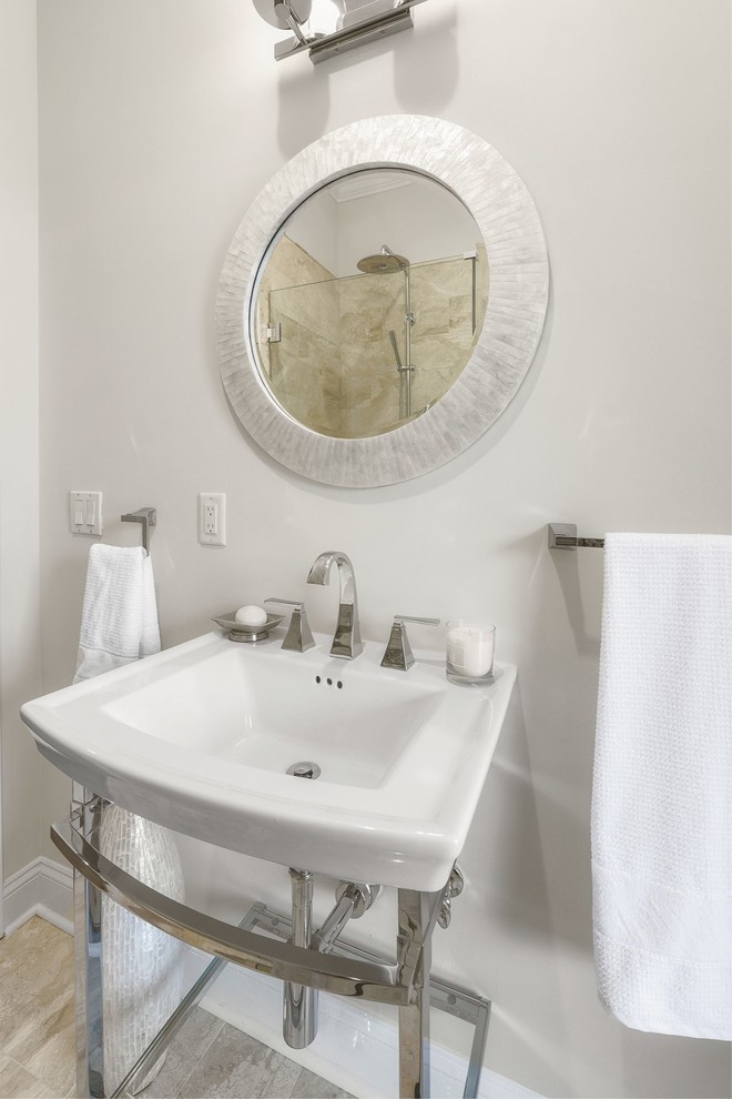 Inspiration for a mid-sized transitional 3/4 beige tile and marble tile marble floor and beige floor alcove shower remodel in Jacksonville with a two-piece toilet, beige walls, a console sink and a hinged shower door