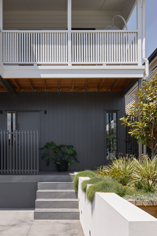 Design ideas for a contemporary two-storey black house exterior in Brisbane with metal siding, a metal roof and a black roof.