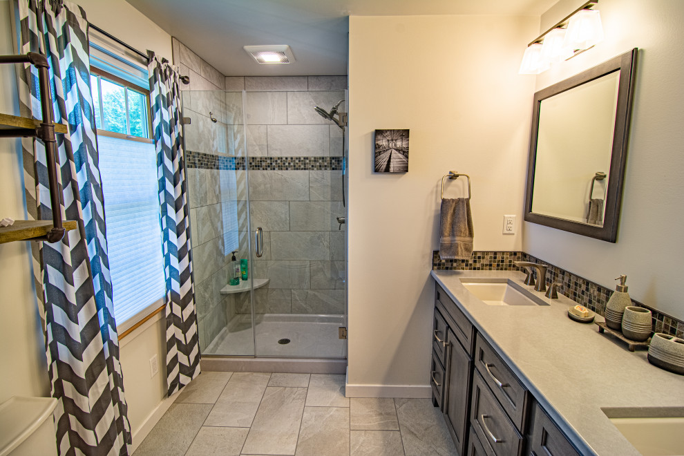 This is an example of a mid-sized transitional master bathroom in Philadelphia with flat-panel cabinets, grey cabinets, an alcove shower, a two-piece toilet, beige tile, porcelain tile, grey walls, porcelain floors, an undermount sink, engineered quartz benchtops, beige floor, a hinged shower door and grey benchtops.