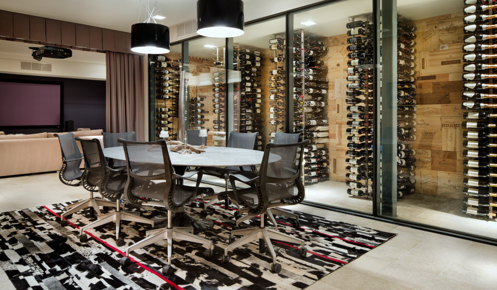 Expansive contemporary wine cellar in Austin with limestone floors, storage racks and grey floor.