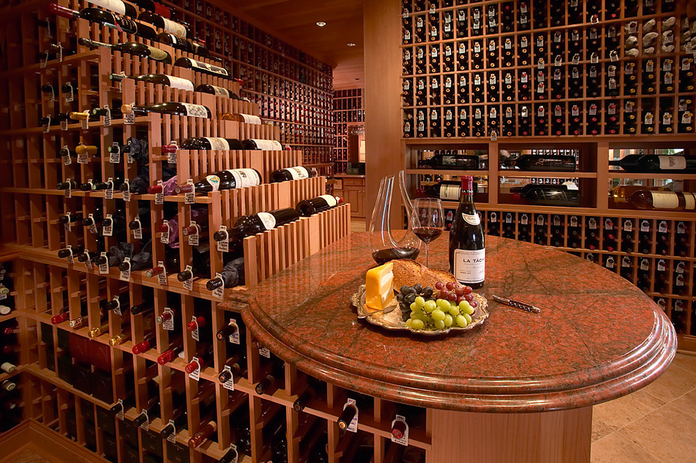 Inspiration for an expansive traditional wine cellar in Los Angeles with terra-cotta floors and display racks.