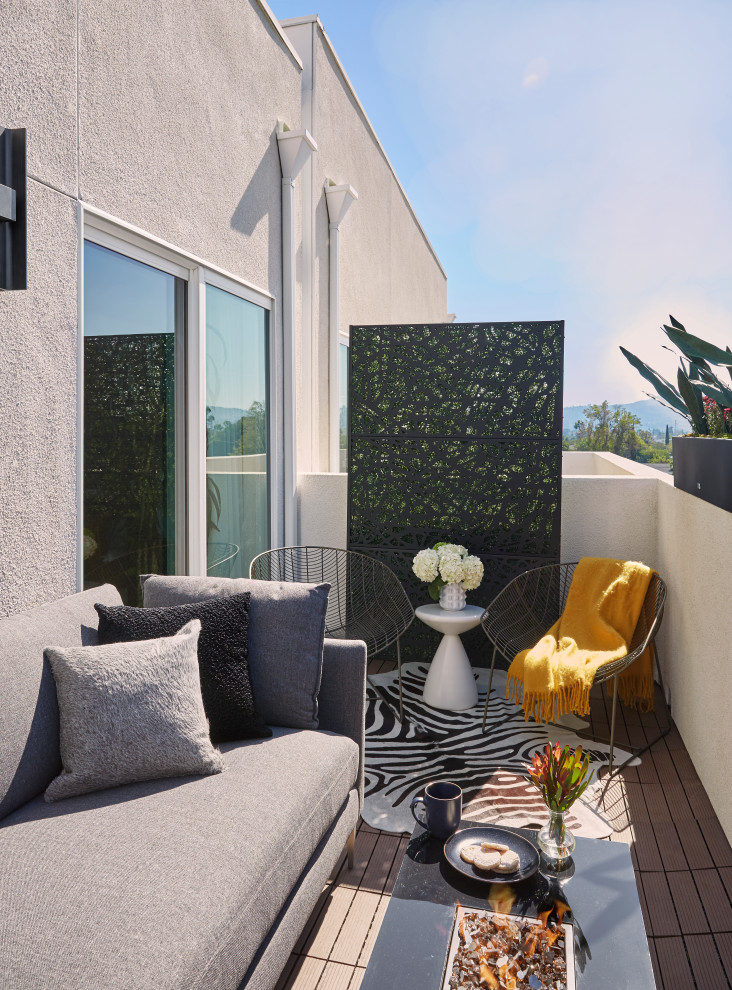Design ideas for a small modern back patio in Los Angeles with a fire feature, concrete slabs and no cover.