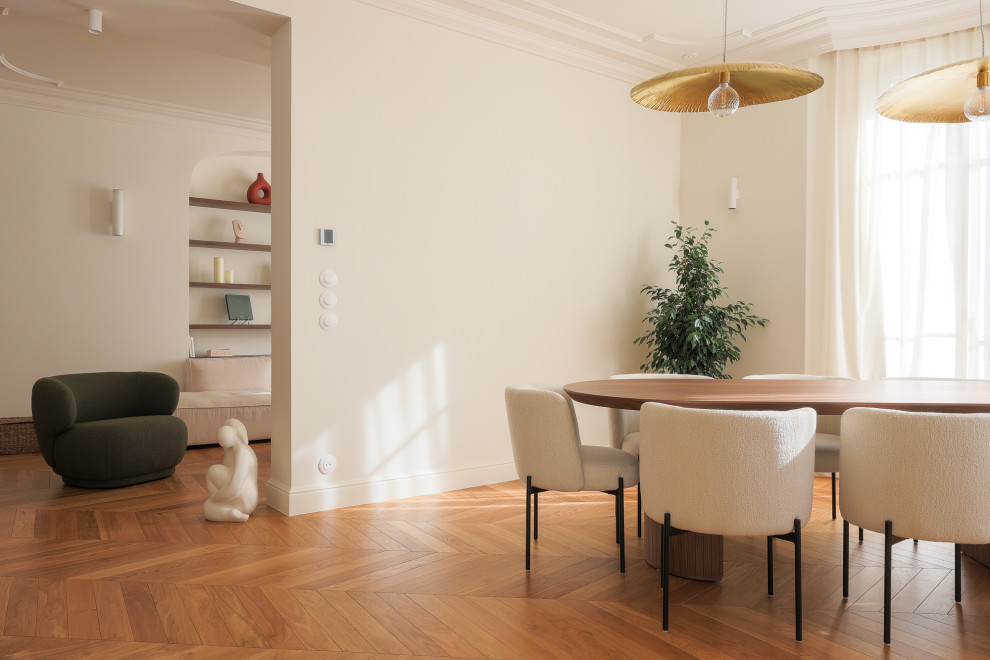 This is an example of a large traditional kitchen/dining room in Nice with white walls, light hardwood flooring, no fireplace and brown floors.