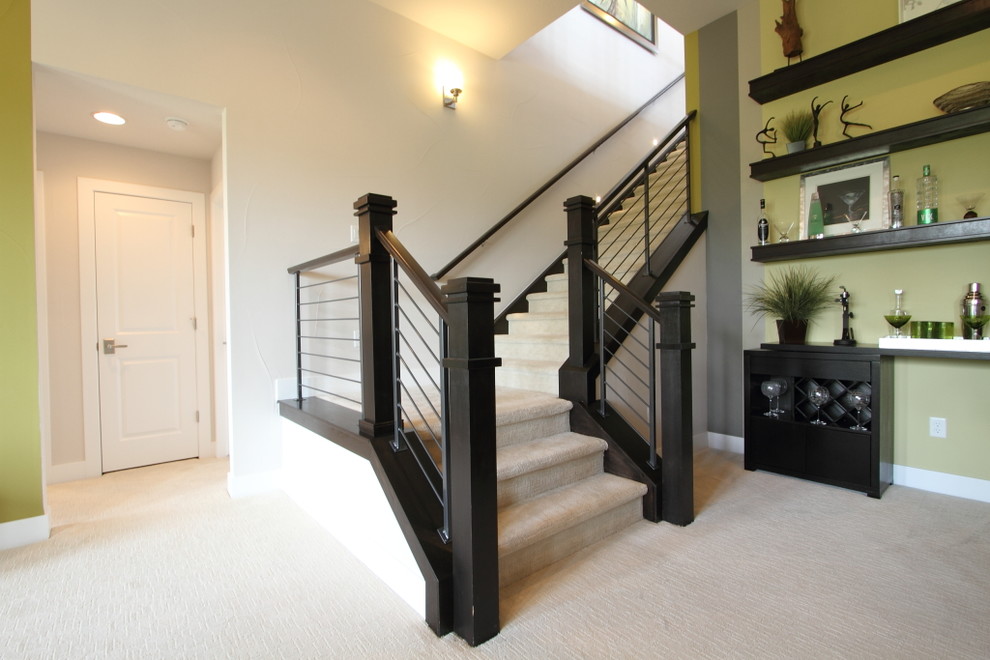 Photo of a large transitional carpeted l-shaped staircase in Denver with carpet risers and wood railing.