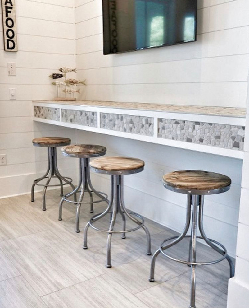 Photo of a beach style home bar in Other with limestone benchtops.