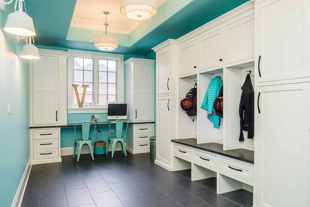 Large transitional mudroom in Chicago with blue walls and dark hardwood floors.