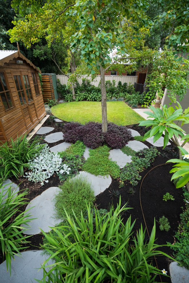 Photo of a small contemporary partial sun backyard stone landscaping in Perth for spring.