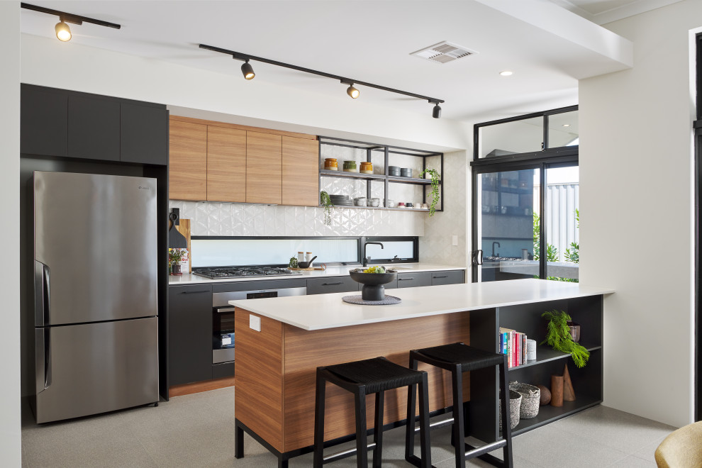 Inspiration for a large contemporary galley kitchen in Perth with flat-panel cabinets, black cabinets, white splashback, stainless steel appliances, a peninsula, grey floor and white benchtop.