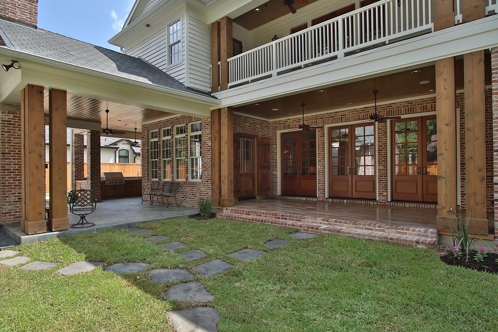 Inspiration for an expansive traditional backyard deck in Houston with a roof extension.