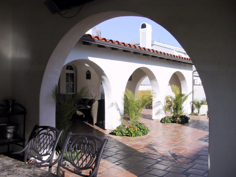 This is an example of an expansive country two-storey stucco white exterior in Orange County with a gable roof.