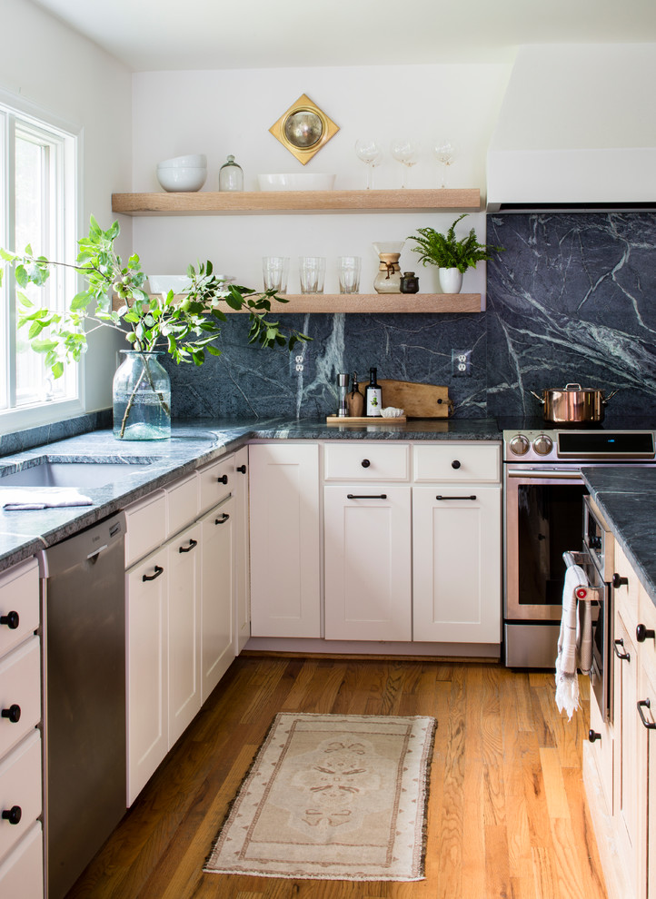 Inspiration for a large country l-shaped open plan kitchen in DC Metro with an undermount sink, shaker cabinets, light wood cabinets, soapstone benchtops, green splashback, stone slab splashback, stainless steel appliances, light hardwood floors, with island and green benchtop.