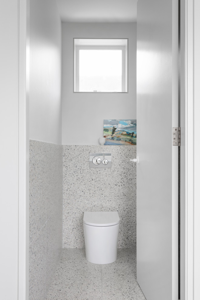 Photo of a contemporary cloakroom in Melbourne with white tiles, terrazzo flooring, beige worktops and a floating vanity unit.