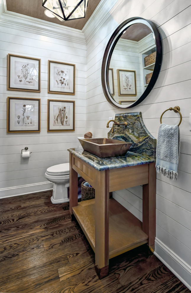 Design ideas for a small traditional bathroom in Charleston with furniture-like cabinets, light wood cabinets, a two-piece toilet, medium hardwood floors, a vessel sink, marble benchtops, brown floor, blue benchtops, a single vanity, a built-in vanity, wallpaper and planked wall panelling.