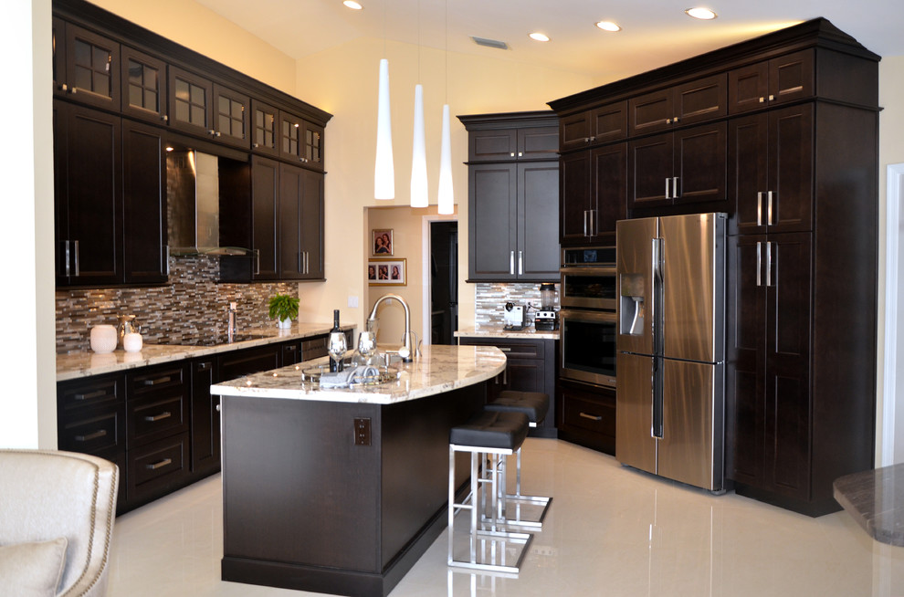 Example of a large transitional l-shaped porcelain tile open concept kitchen design in Miami with an undermount sink, recessed-panel cabinets, dark wood cabinets, granite countertops, multicolored backsplash, mosaic tile backsplash, stainless steel appliances and an island