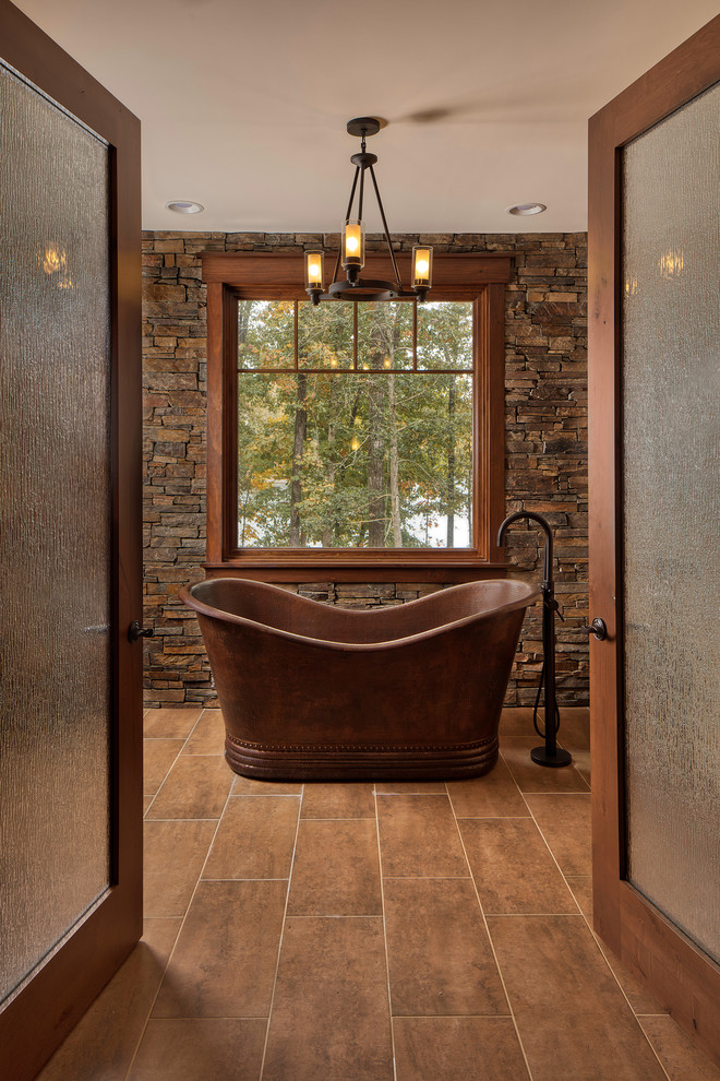 Inspiration for a rustic brown floor freestanding bathtub remodel in Other