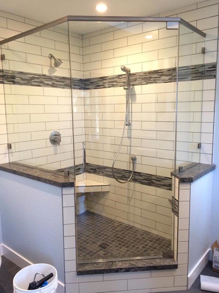 Design ideas for a mid-sized transitional bathroom in San Francisco with a corner shower, black tile, black and white tile, white tile, matchstick tile, white walls and a hinged shower door.