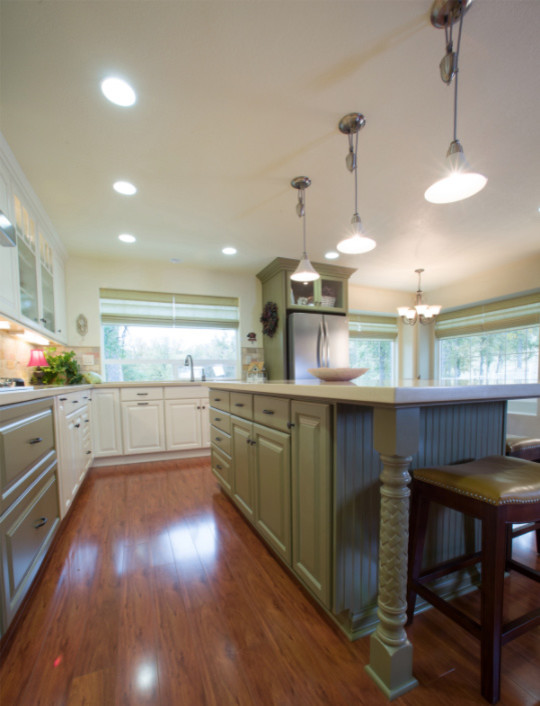 Inspiration for a mid-sized transitional l-shaped medium tone wood floor open concept kitchen remodel with a double-bowl sink, raised-panel cabinets, white cabinets, white backsplash, stainless steel appliances and an island