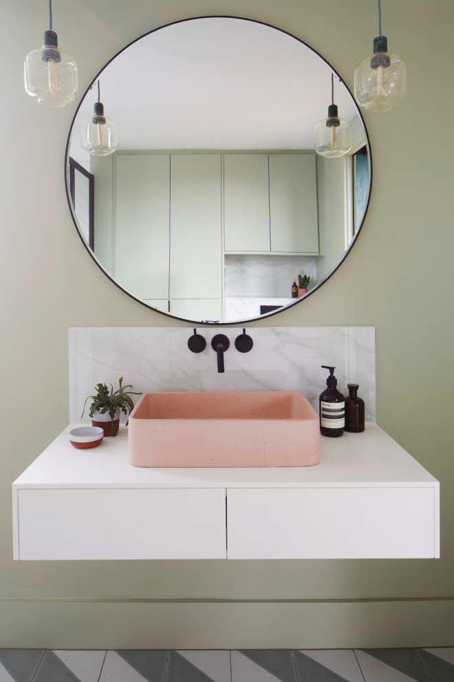 Idéer för små funkis en-suite badrum, med släta luckor, vita skåp, en vägghängd toalettstol, grön kakel, keramikplattor, gröna väggar, klinkergolv i keramik, ett avlångt handfat, marmorbänkskiva, flerfärgat golv och dusch med skjutdörr