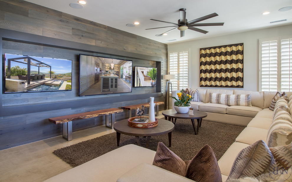 This is an example of a large transitional open concept living room in Orange County with multi-coloured walls, light hardwood floors, no fireplace and a built-in media wall.