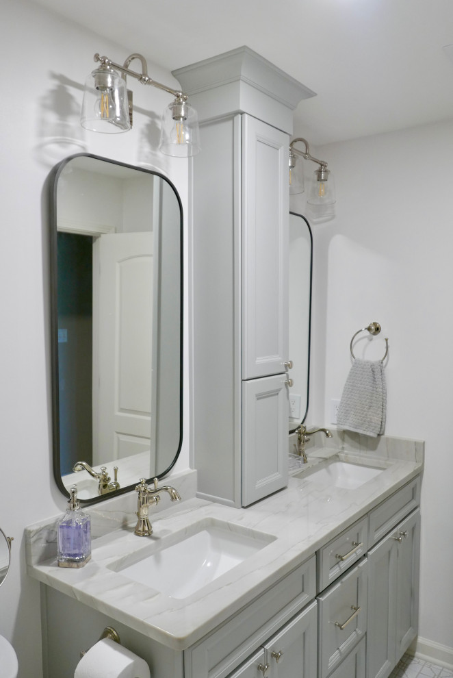 This is an example of a mid-sized transitional kids bathroom in Other with recessed-panel cabinets, grey cabinets, an alcove tub, a shower/bathtub combo, a two-piece toilet, white tile, porcelain tile, white walls, mosaic tile floors, an undermount sink, quartzite benchtops, white floor, a shower curtain, grey benchtops, a niche, a double vanity and a built-in vanity.