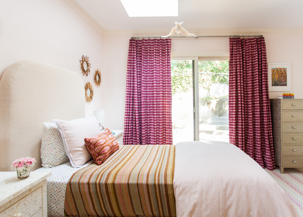 This is an example of a transitional guest bedroom in San Francisco with pink walls, carpet and multi-coloured floor.