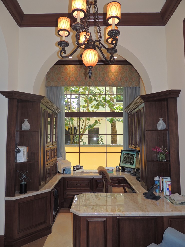 Photo of a large traditional study room in Miami with beige walls, ceramic floors and a built-in desk.