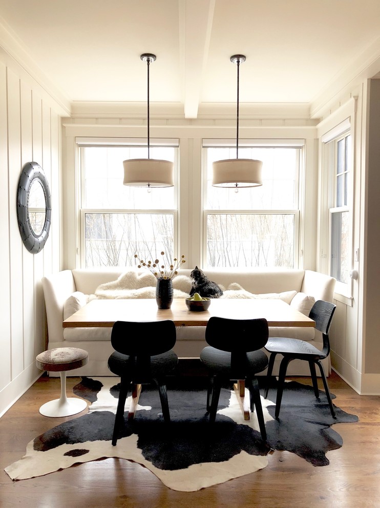Traditional dining room in Boston with white walls and medium hardwood floors.