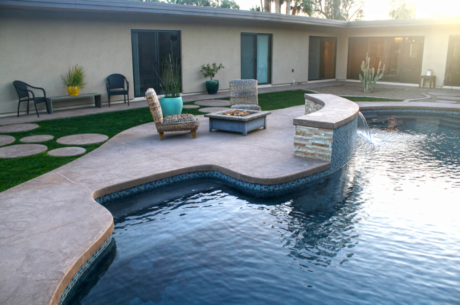 Photo of a mid-sized contemporary backyard kidney-shaped natural pool in Phoenix with concrete pavers.