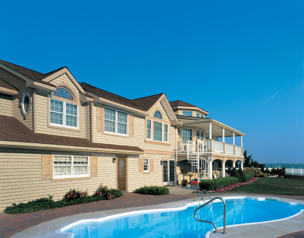 Inspiration for a large beach style two-storey beige exterior in Philadelphia with vinyl siding.