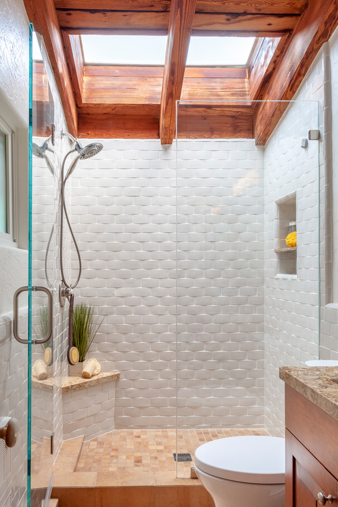 Inspiration for a mid-sized mediterranean 3/4 bathroom in Los Angeles with white tile, ceramic tile, white walls, an alcove shower and a hinged shower door.