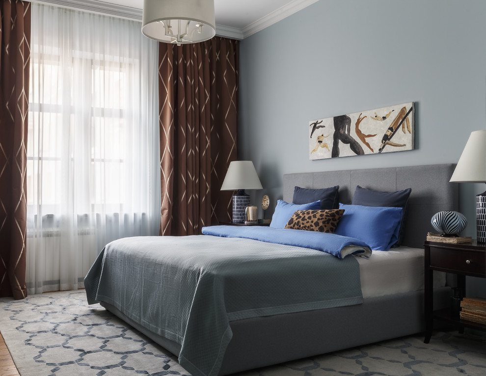 This is an example of a transitional bedroom in Moscow with blue walls.