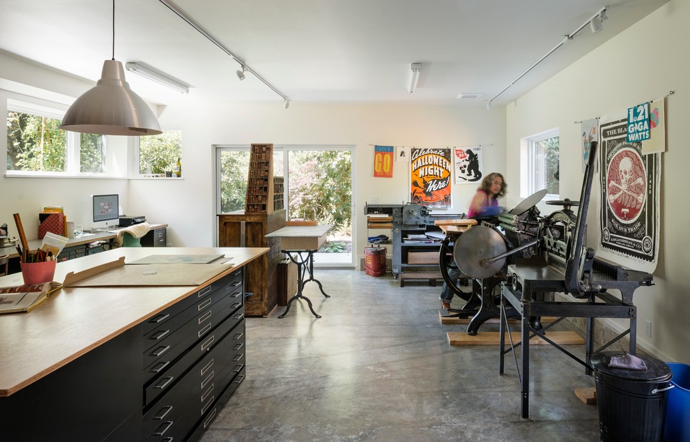 This is an example of a mid-sized midcentury home studio in Seattle with concrete floors.
