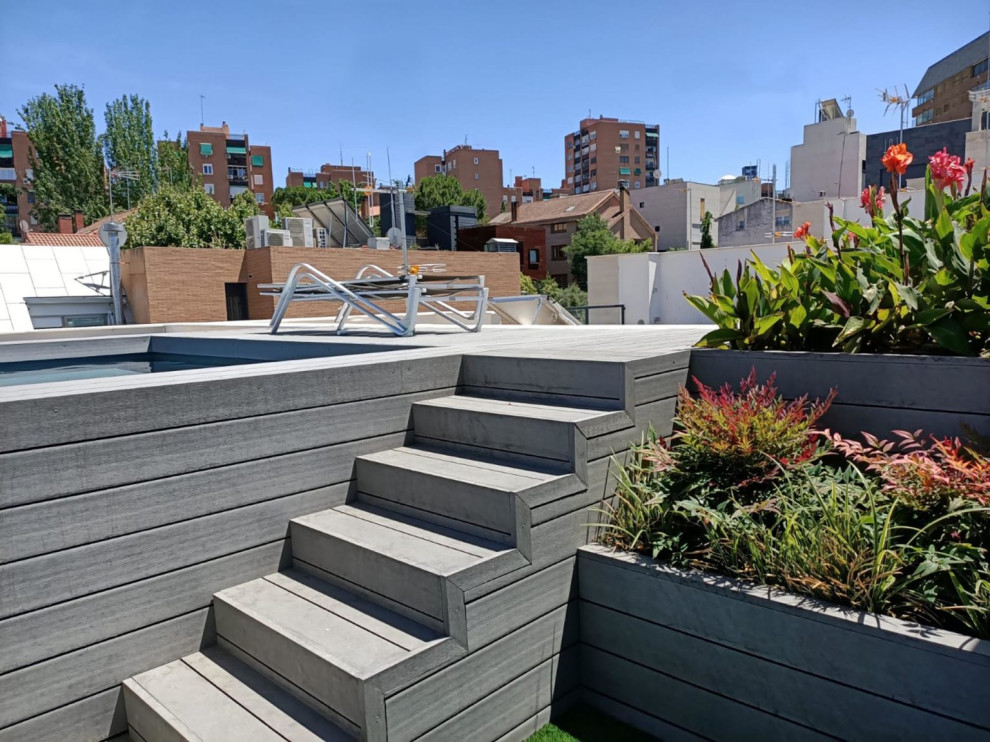 This is an example of a mid-sized modern rooftop rectangular aboveground pool in Madrid.