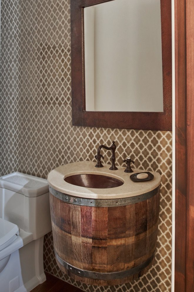 This is an example of a medium sized mediterranean cloakroom in San Francisco with flat-panel cabinets, a submerged sink and a built in vanity unit.