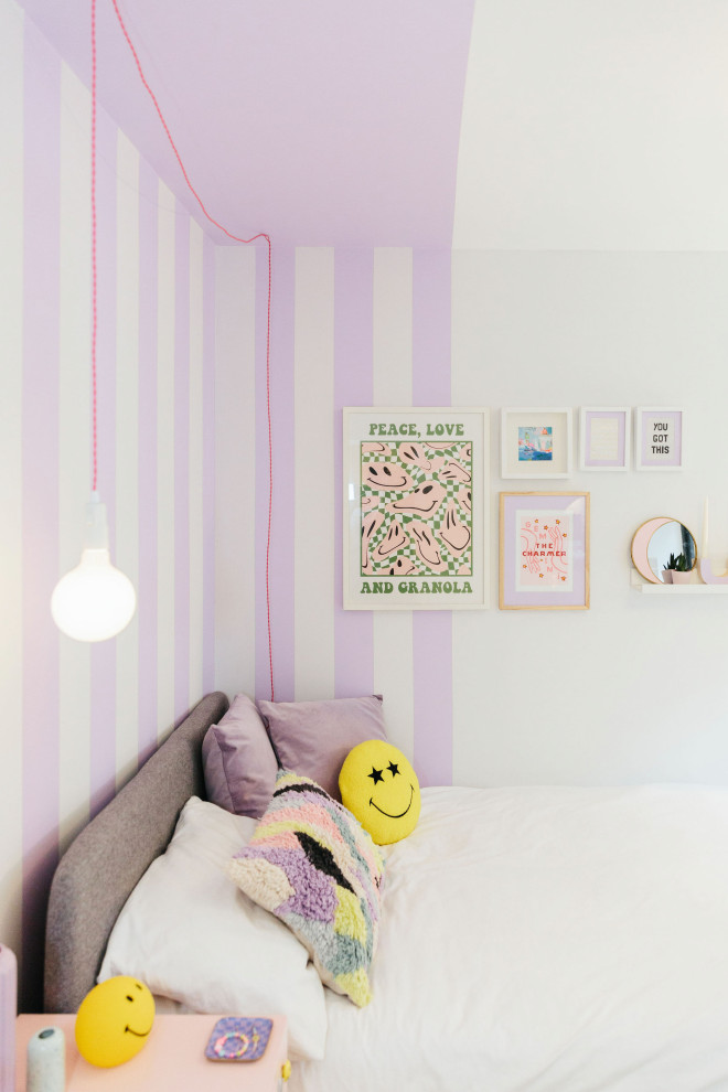 Mid-sized modern kids' room in Dorset with purple walls, light hardwood floors and brown floor for girls.