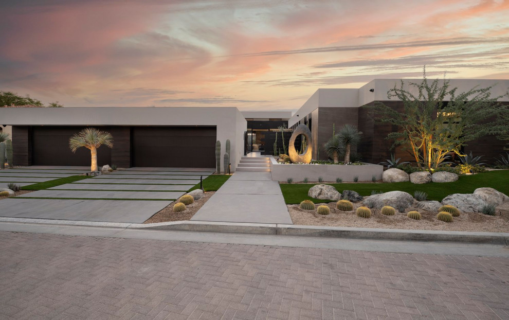 Inspiration for a large and desert look modern front yard full sun xeriscape in Los Angeles with gravel and a wood fence.