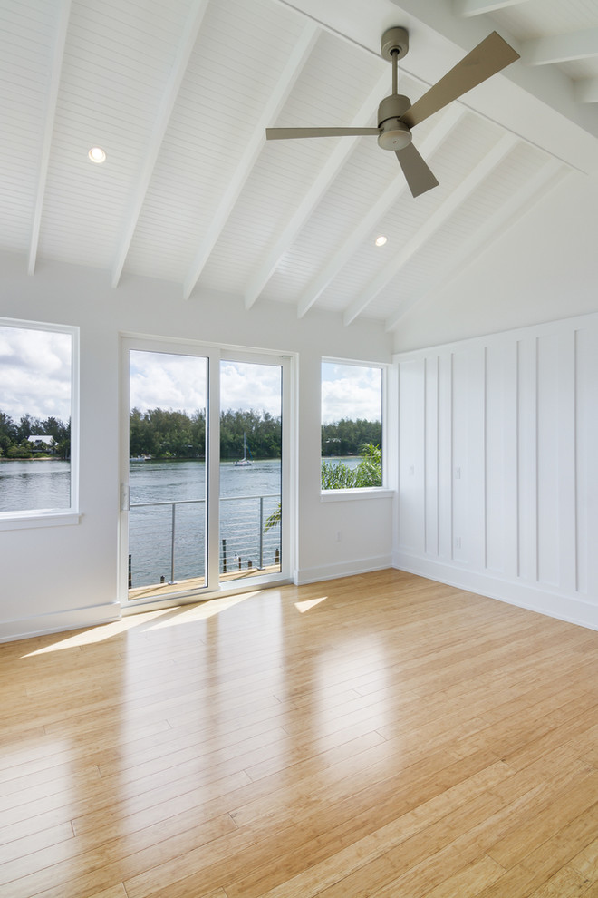 Mid-sized contemporary master bedroom in Tampa with white walls, bamboo floors and no fireplace.