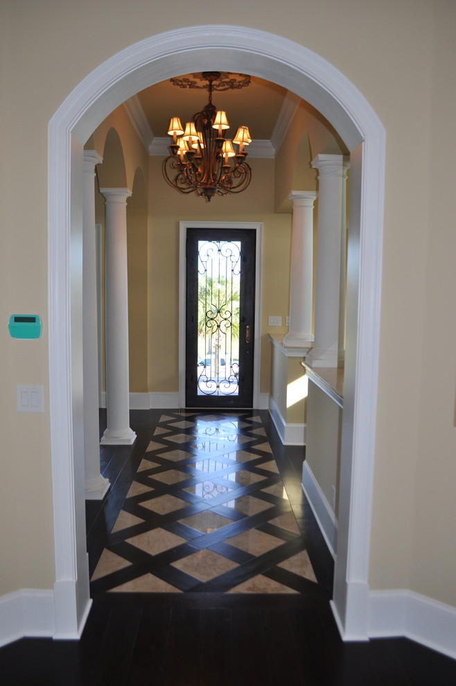 Design ideas for a large transitional hallway in Other with beige walls, dark hardwood floors and multi-coloured floor.
