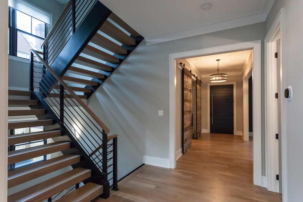 Contemporary wood u-shaped staircase in DC Metro with open risers and mixed railing.