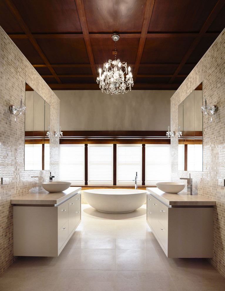Design ideas for a mid-sized traditional master bathroom in Melbourne with white cabinets, a freestanding tub, beige tile, mosaic tile, beige walls, a vessel sink, beige floor, beige benchtops, a double vanity, a floating vanity and wood.