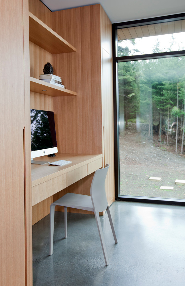 Small modern study room in Vancouver with concrete floors and a built-in desk.