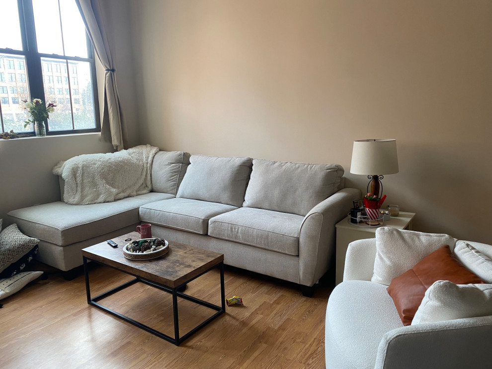 Neutral tan sofa with blue-grey and celery green throw pillows