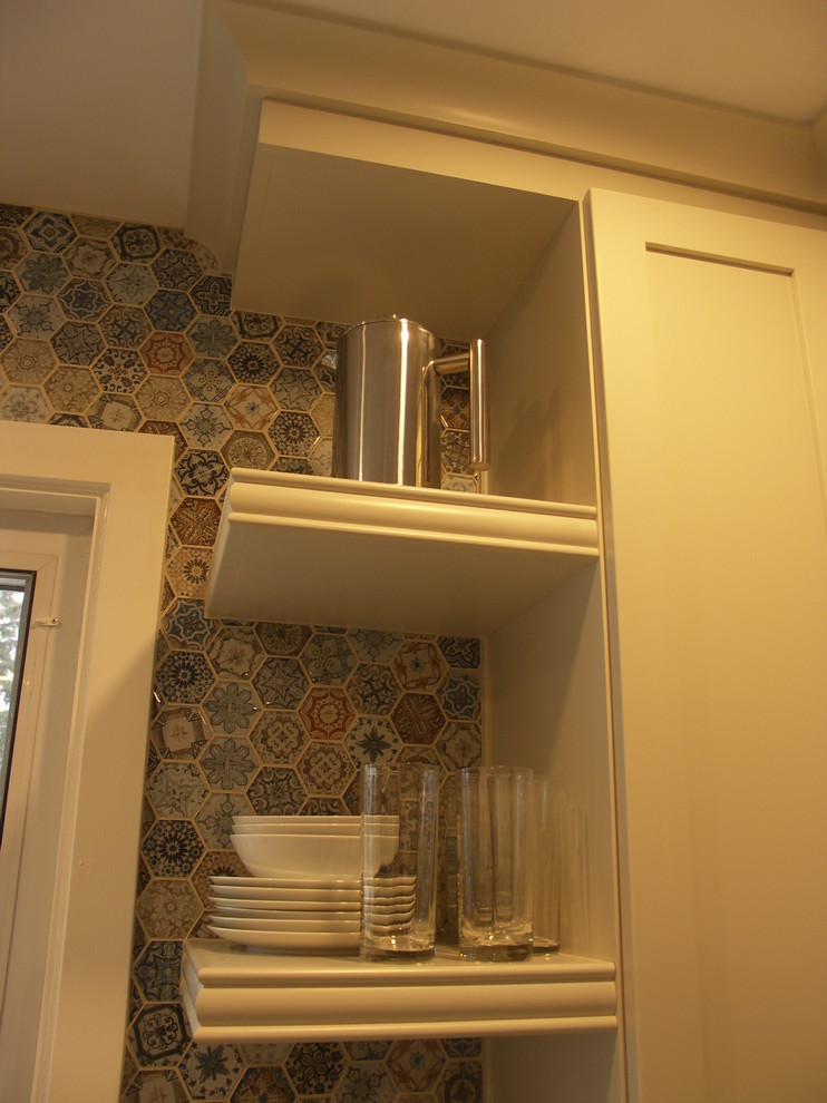 Example of a mid-sized transitional l-shaped eat-in kitchen design in Edmonton with a drop-in sink, shaker cabinets, white cabinets, laminate countertops, multicolored backsplash, ceramic backsplash, stainless steel appliances, no island and brown countertops