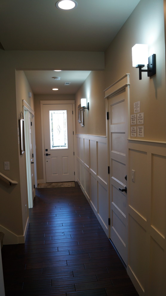 Large arts and crafts hallway in Seattle with white walls and dark hardwood floors.