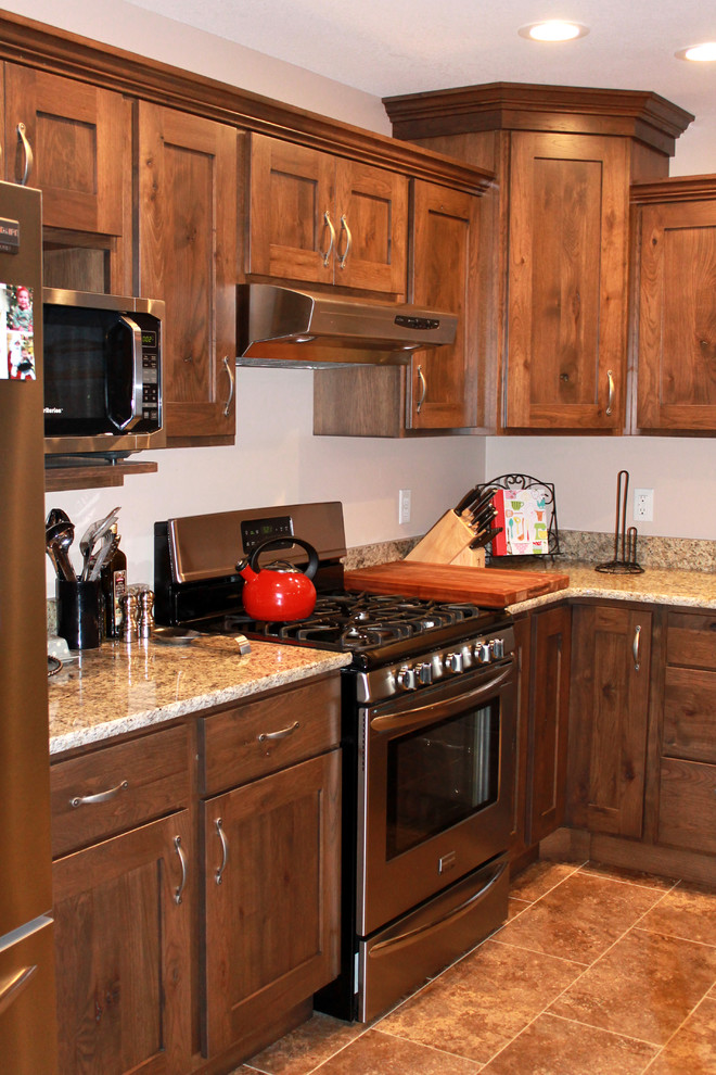 Large mountain style l-shaped eat-in kitchen photo in Chicago with a farmhouse sink, shaker cabinets, dark wood cabinets, granite countertops, stainless steel appliances and an island