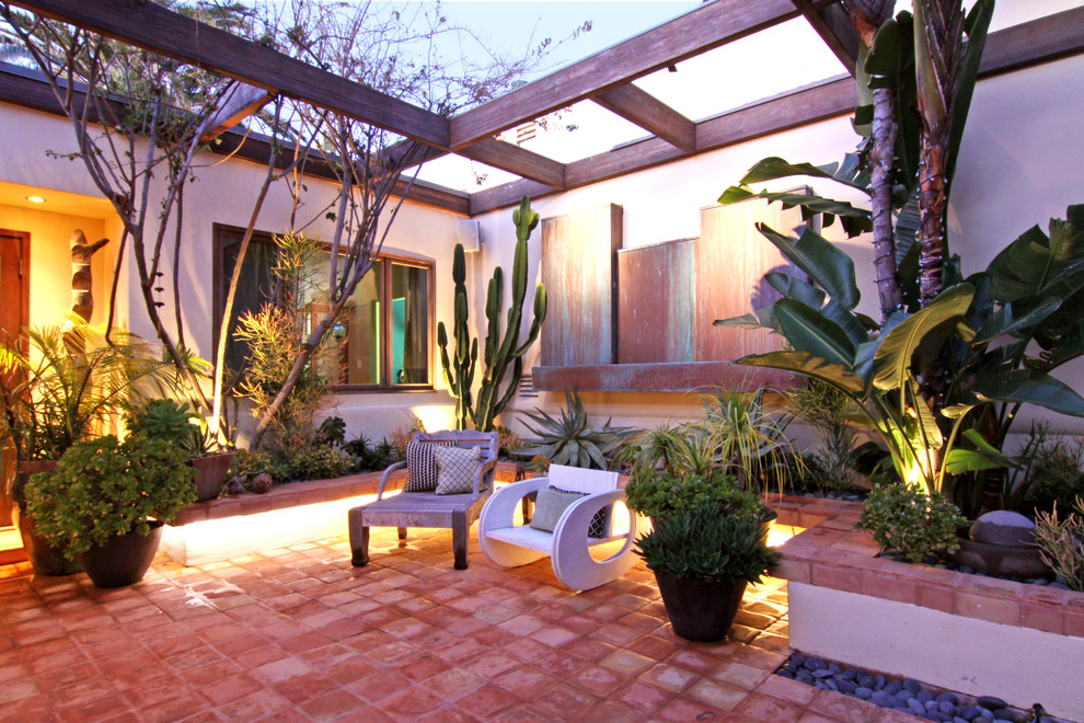 Design ideas for a tropical patio in Orange County with a pergola.
