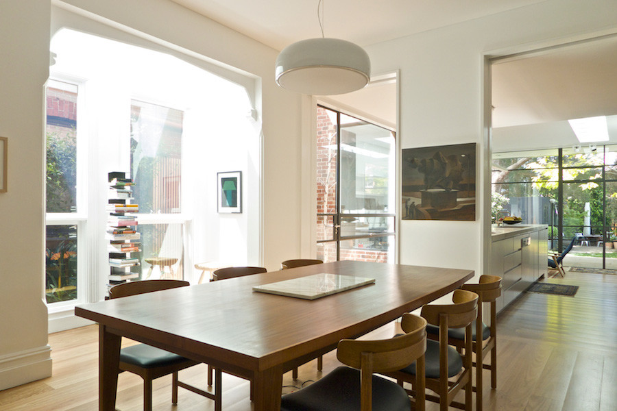 Contemporary separate dining room in Melbourne with white walls and medium hardwood floors.