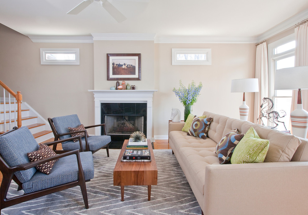 Mid-sized transitional open concept living room in Atlanta with beige walls, medium hardwood floors, a standard fireplace and a tile fireplace surround.
